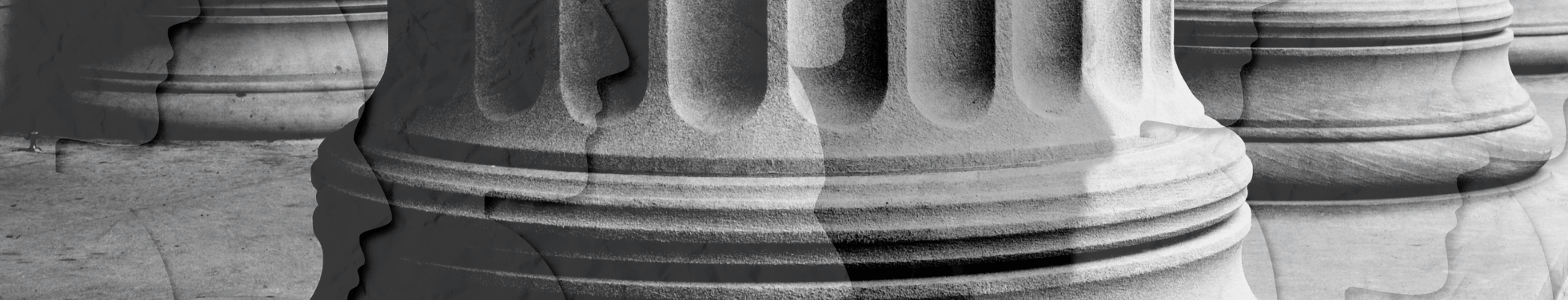Black-and-white close-up of carved stone column bases with detailed architectural craftsmanship.